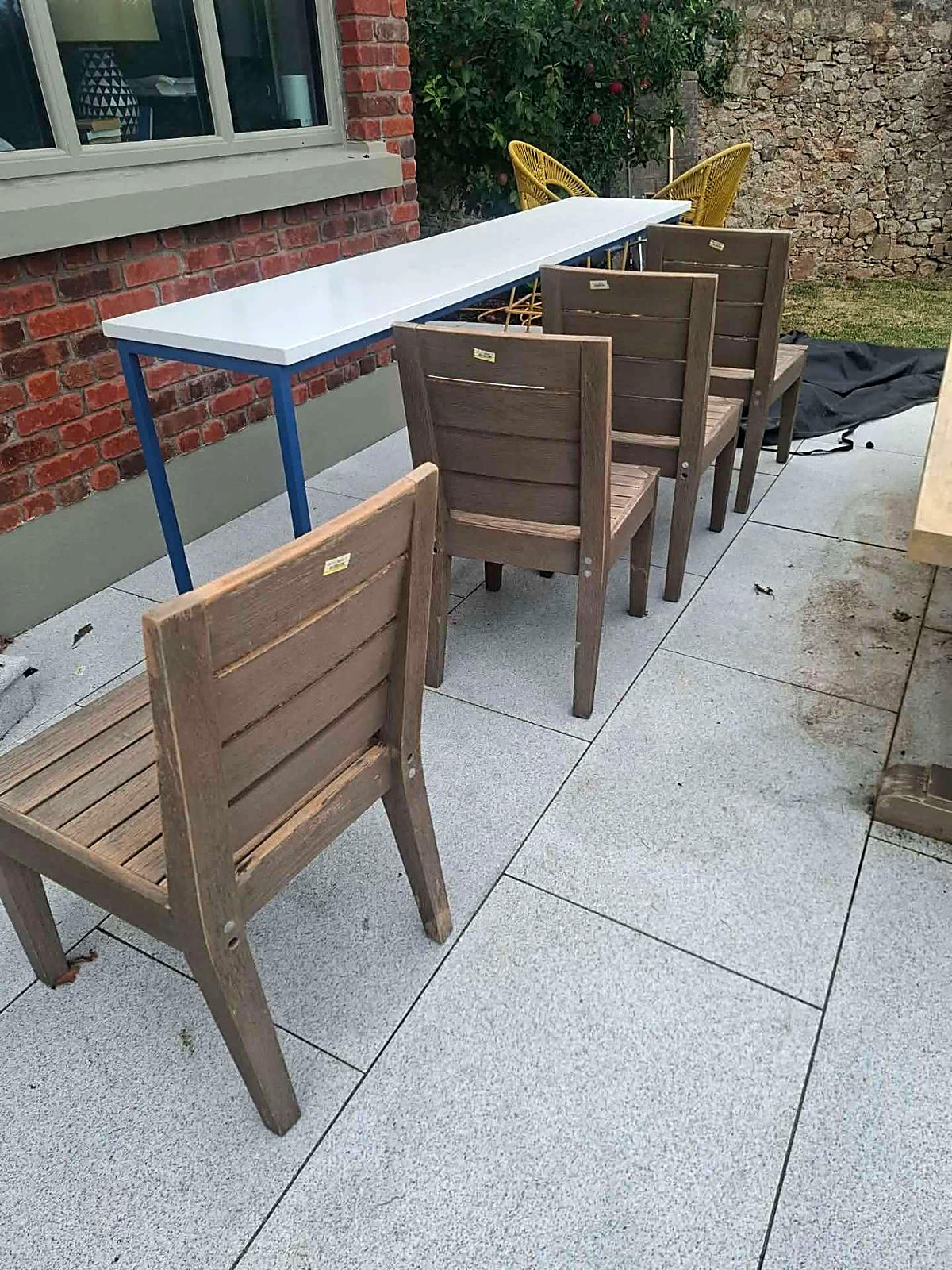 Before: weathered outdoor dining chairs before restoration
