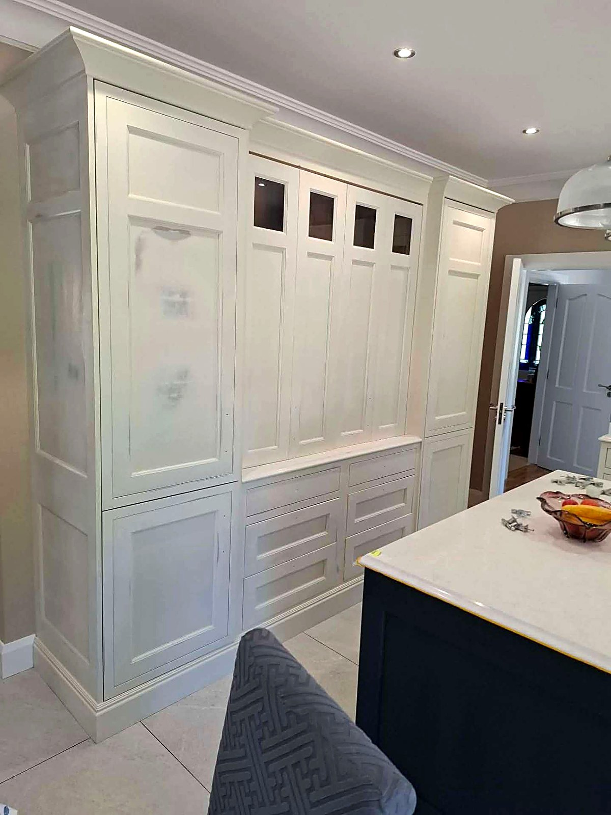 Before: tall cream painted larder units in the same kitchen